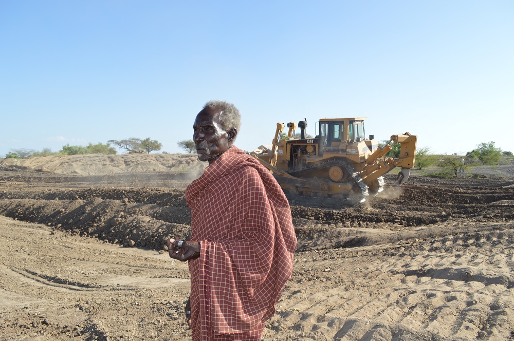A local elder watches as workers employed by the Spanish Nariokotome Mission in northern Turkana build a water catchment. The mission has constructed 186 water projects around Turkana through European and other funding.
